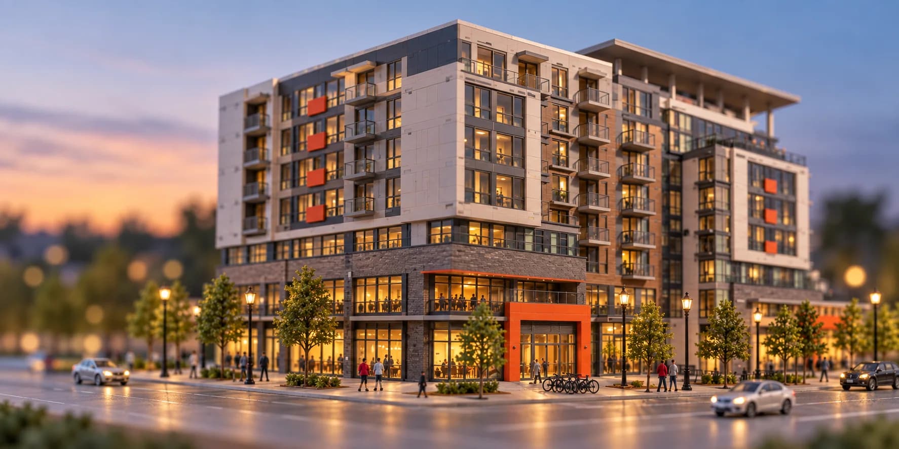 A completed mixed-use apartment development with active ground-floor space at dusk