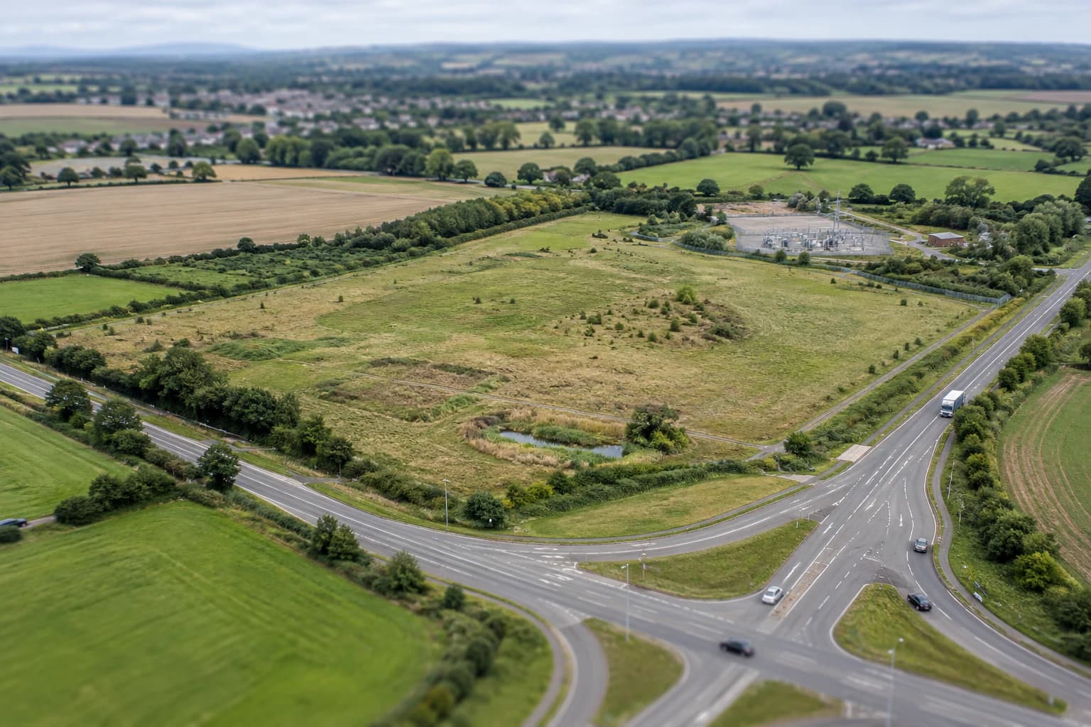 A greenfield site shown with its roads, drainage, utilities, and surrounding development context